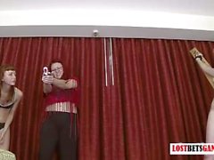 Girl plays the target as 2 others shoot her with foam darts